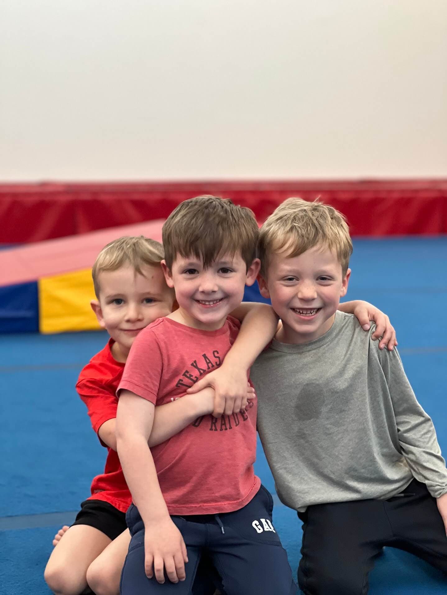 Group of boys smiling with their arms around each other