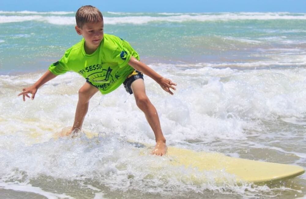 A boy surfing at the beach
