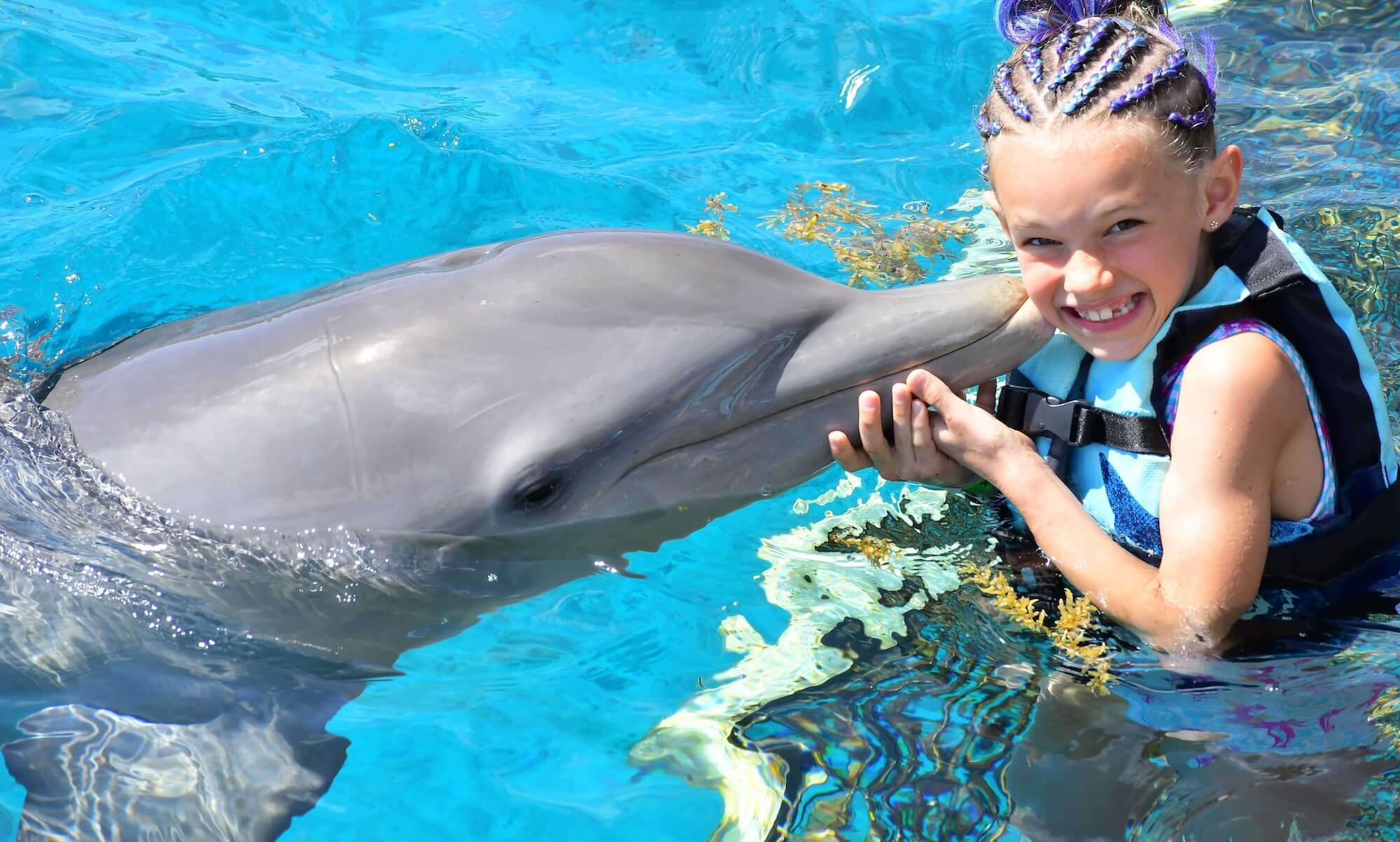 A child performing a handstand on the beach