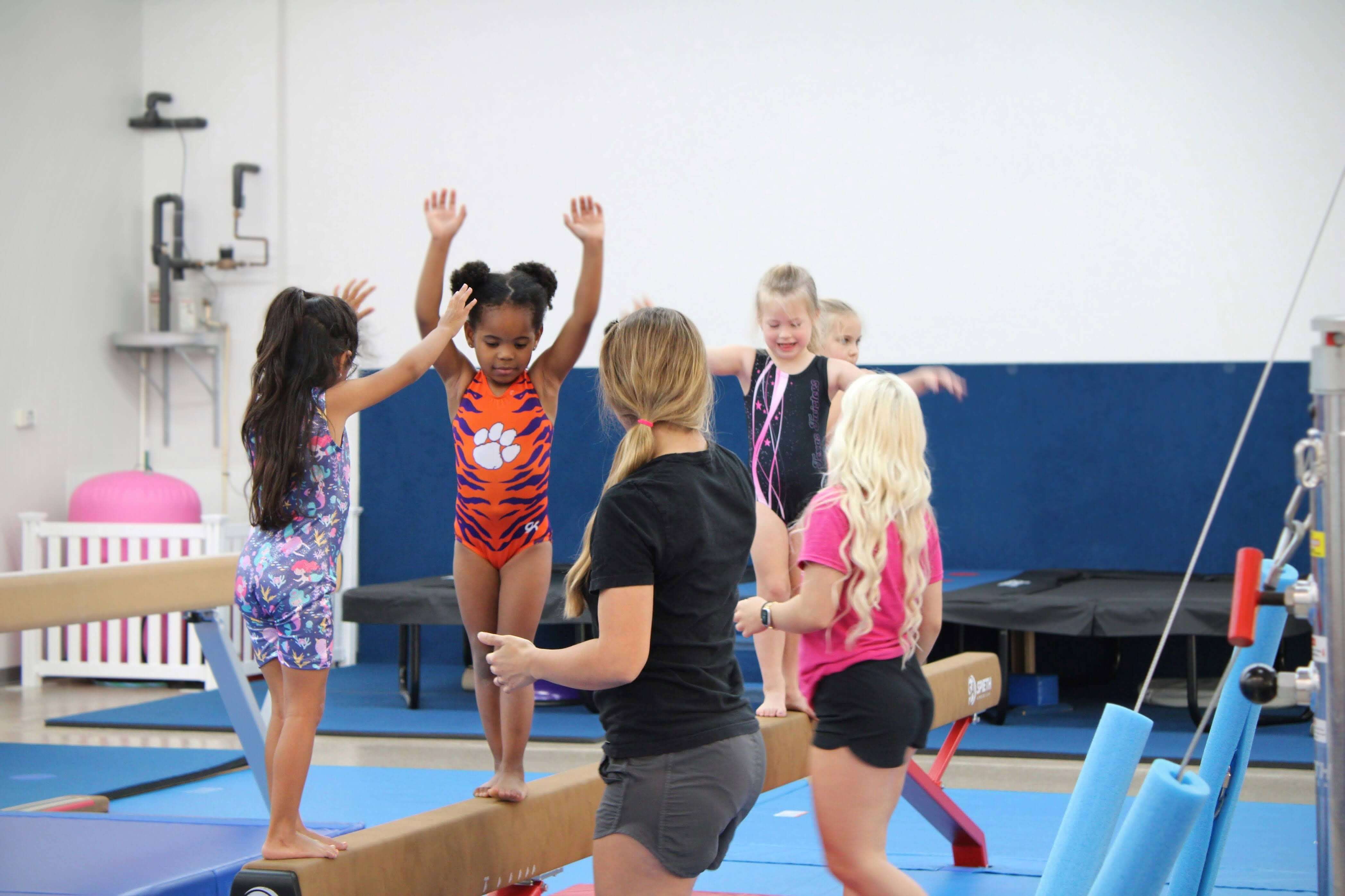 Coach spotting a student on bars