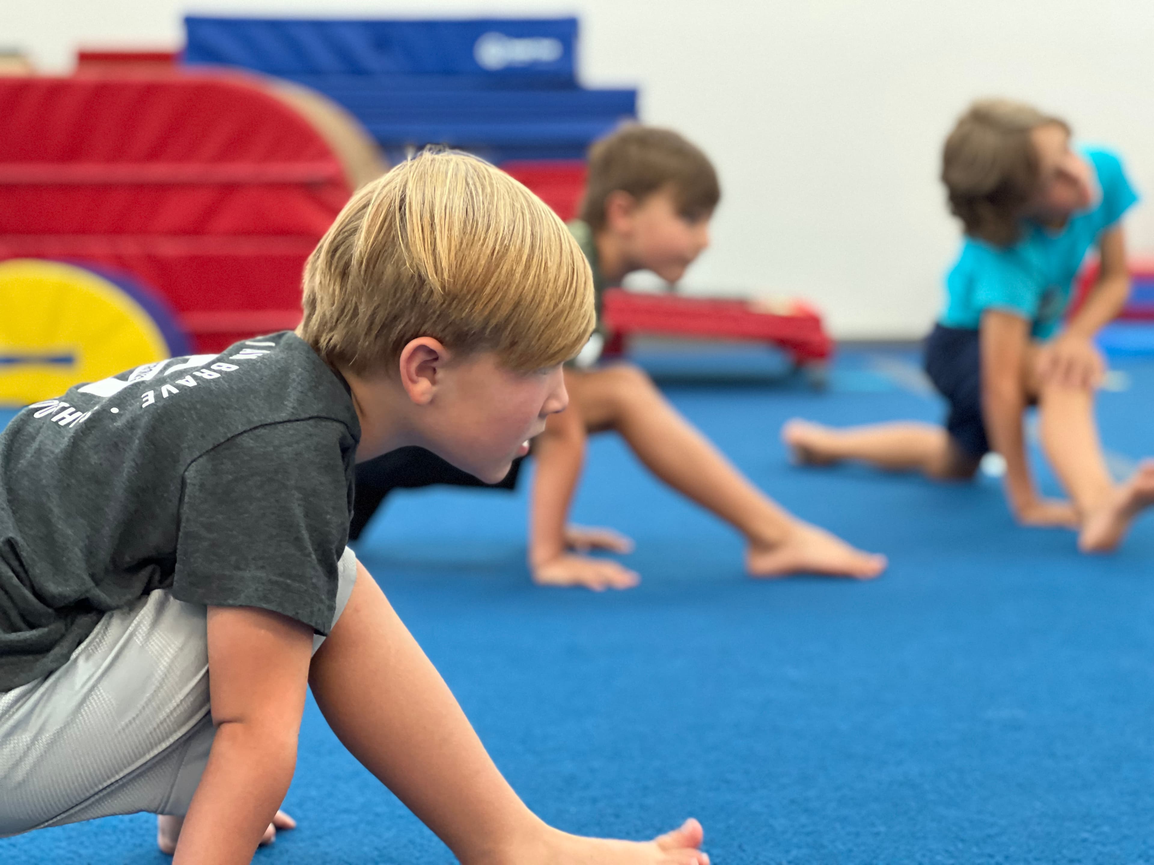Boys stretching on the tumbling floor